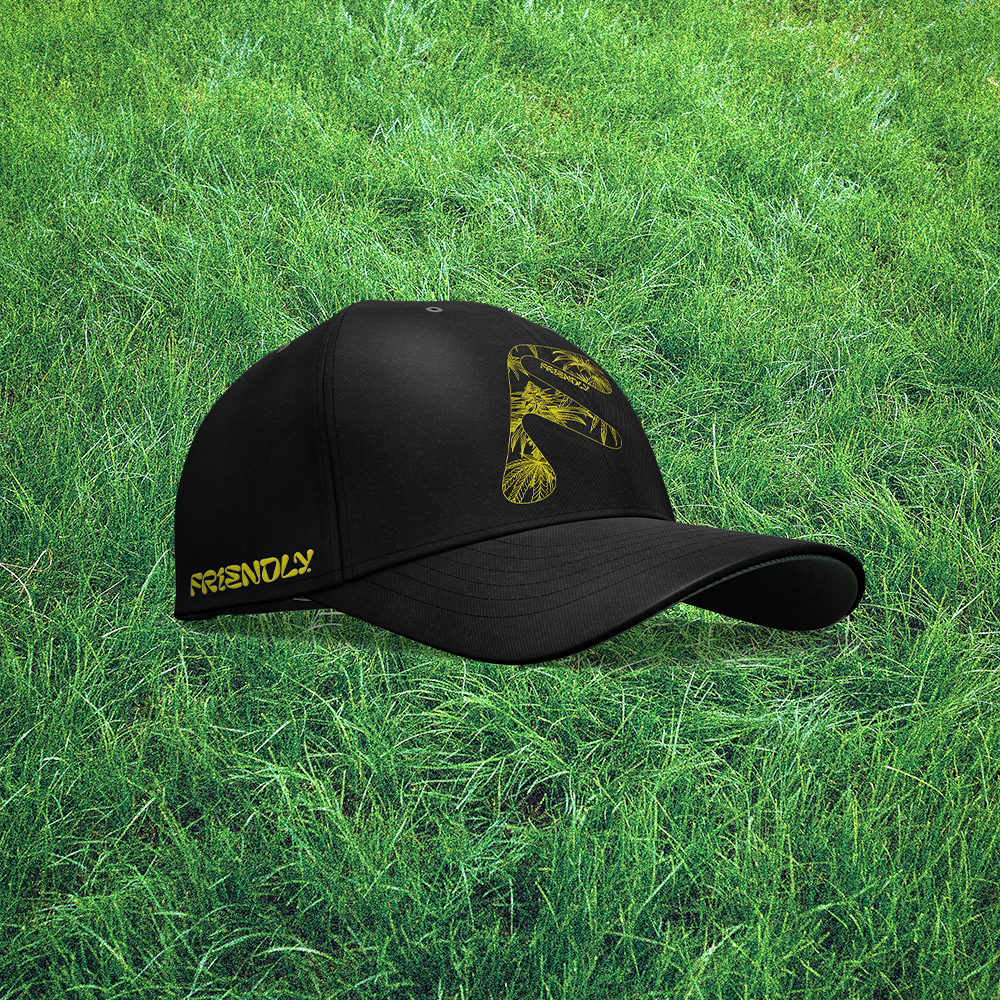 Black Friendly Gear hat on green grass background.
